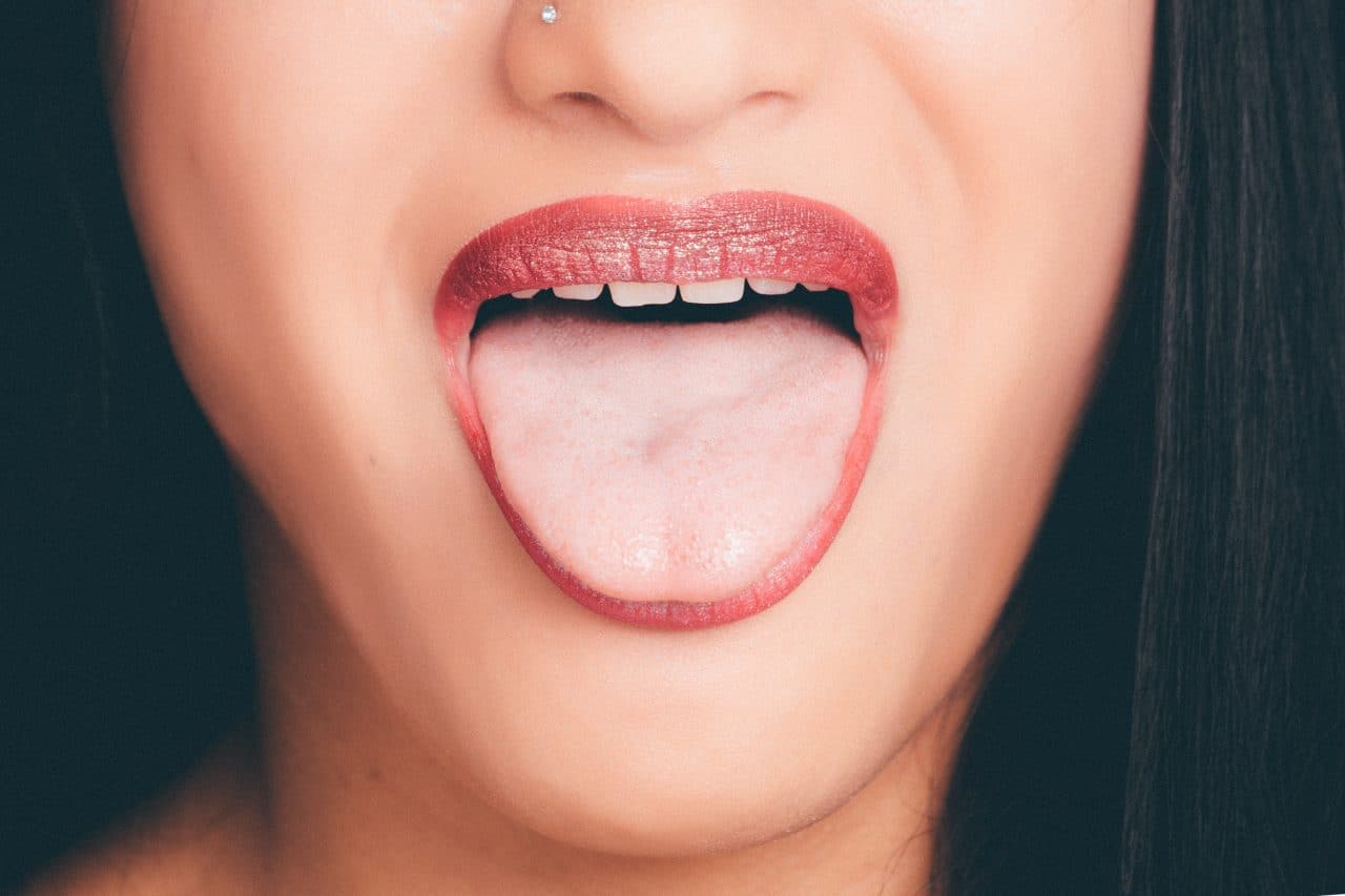 Woman with wide open mouth and tongue out 