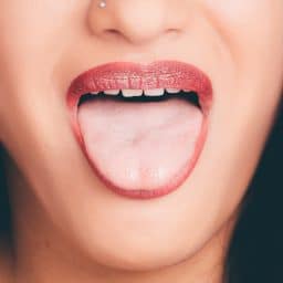 Woman with wide open mouth and tongue out