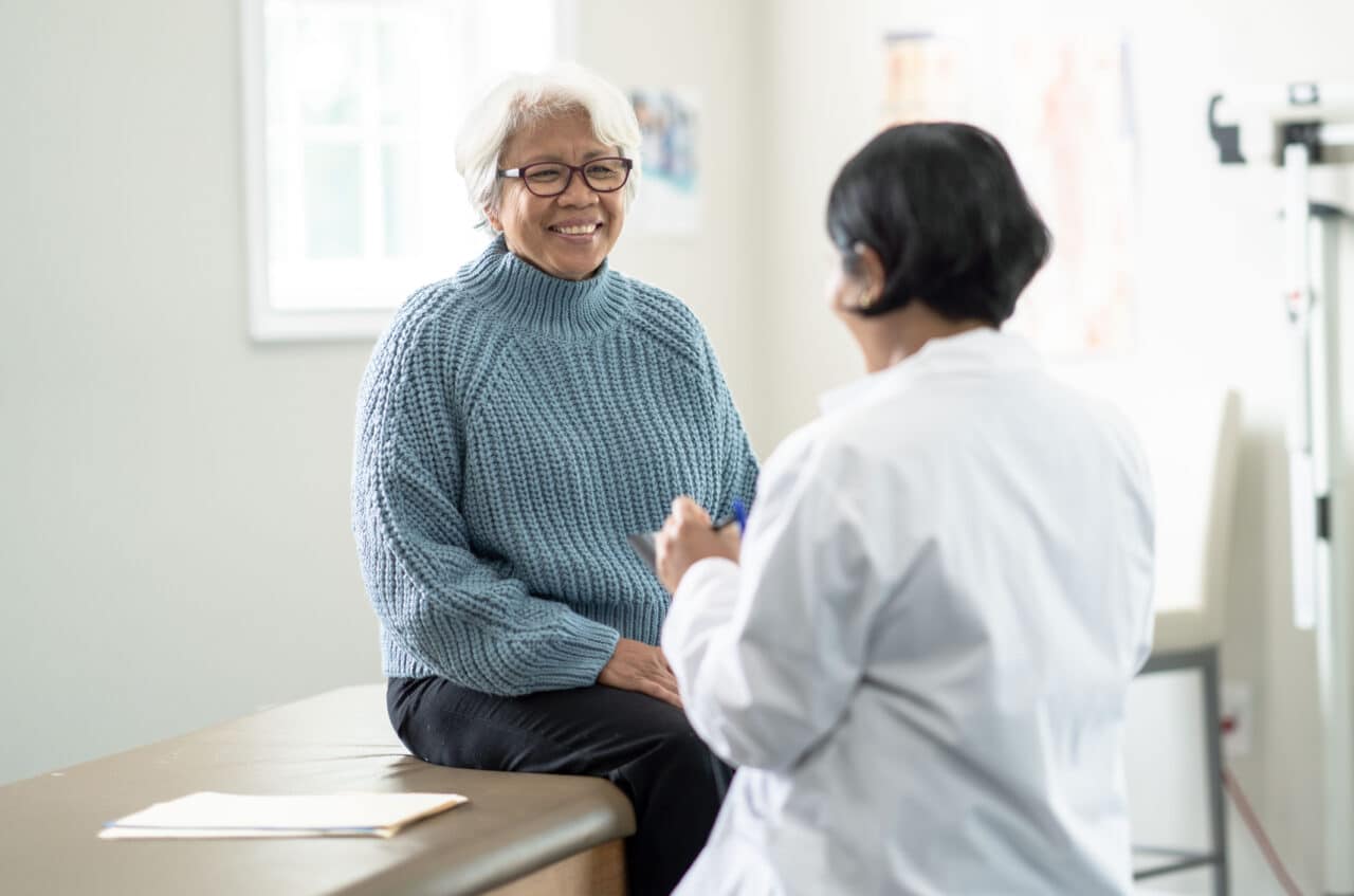Older woman visiting with her doctor.