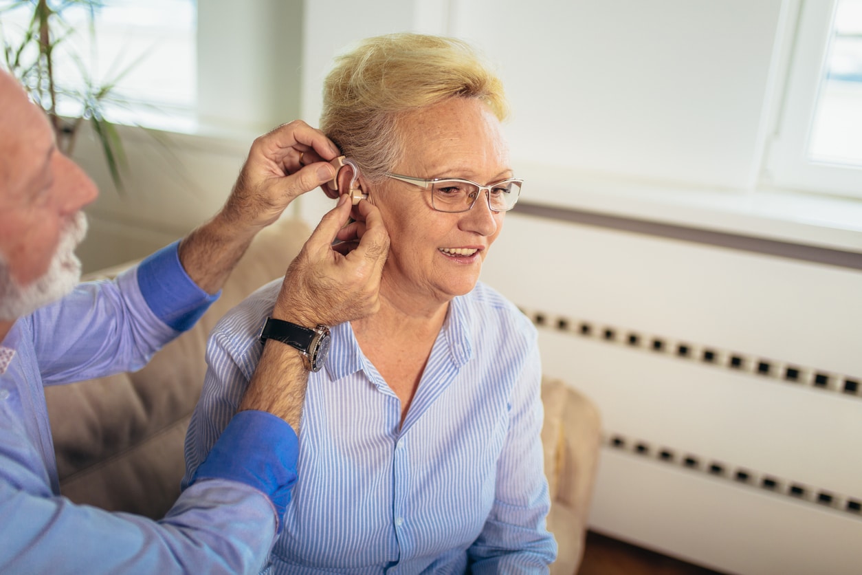 Woman getting a new hearing aid.